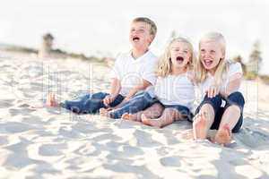 Cute Sibling Children Sitting at the Beach