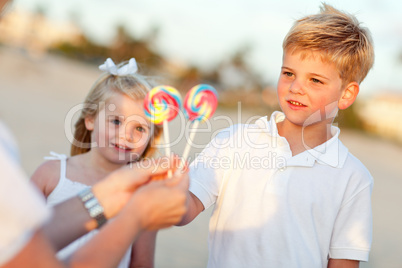 Cute Brother and Sister Picking out Lollipop