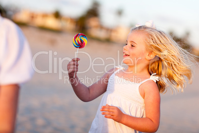 Adorable Little Girl Enjoying Her Lollipop Outside