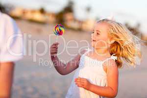 Adorable Little Girl Enjoying Her Lollipop Outside