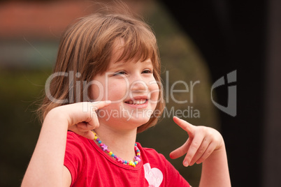 Adorable Girl Poses While Playing