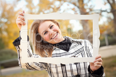 Pretty Young Woman Smiling in the Park with Picture Frame