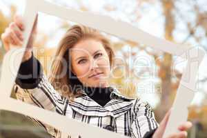 Pretty Young Woman Smiling in the Park with Picture Frame