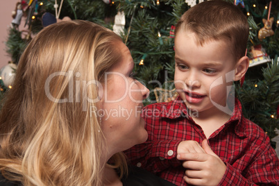 Adorable Son Talking to Mom in Front Of Christmas Tree