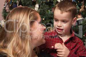 Adorable Son Talking to Mom in Front Of Christmas Tree