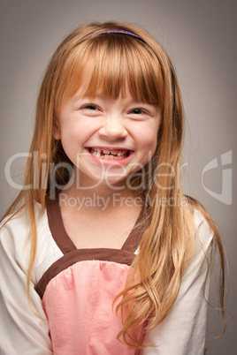 Fun Portrait of an Adorable Red Haired Girl on Grey