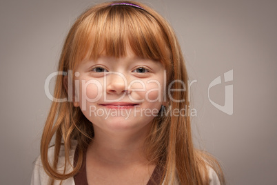 Fun Portrait of an Adorable Red Haired Girl on Grey