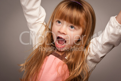 Fun Portrait of an Adorable Red Haired Girl on Grey