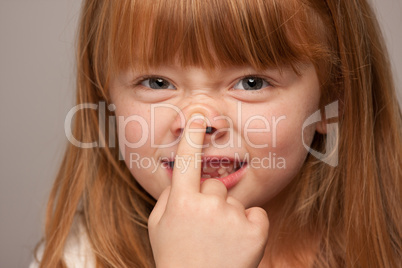 Fun Portrait of an Adorable Red Haired Girl on Grey