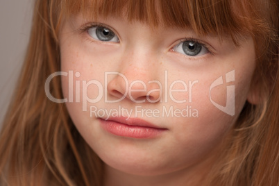 Fun Portrait of an Adorable Red Haired Girl on Grey