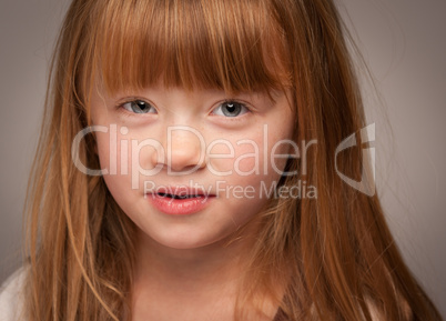 Fun Portrait of an Adorable Red Haired Girl on Grey