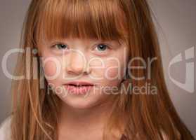 Fun Portrait of an Adorable Red Haired Girl on Grey