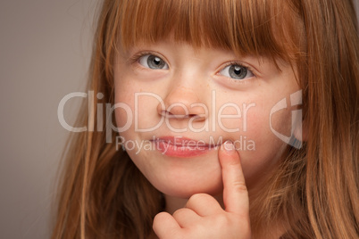 Fun Portrait of an Adorable Red Haired Girl on Grey