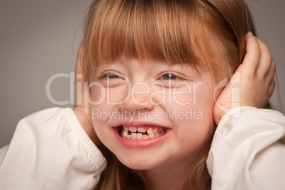 Fun Portrait of an Adorable Red Haired Girl on Grey