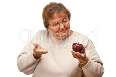 Confused Senior Woman Holding Apple and Vitamins