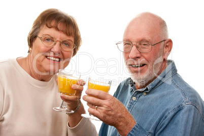 Happy Senior Couple with Glasses of Orange Juice