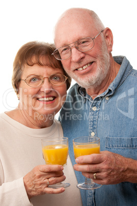 Happy Senior Couple with Glasses of Orange Juice