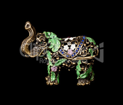 Metal elephant with crystals on the black background (souvenir)