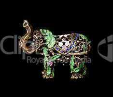Metal elephant with crystals on the black background (souvenir)
