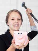 girl  about to break his piggy bank with hammer