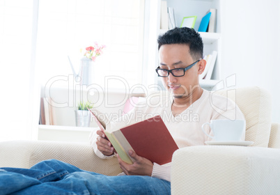 Southeast Asian male reading book