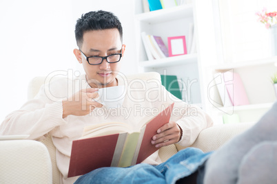 Southeast Asian male reading a book