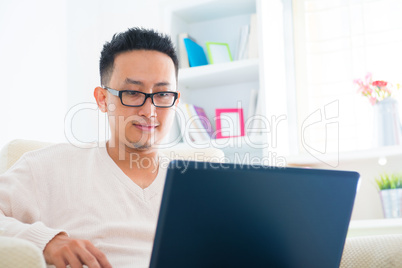 Asian male using notebook