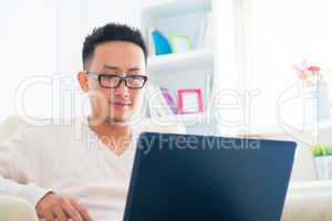 Asian male using notebook