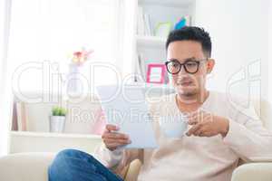 Asian male using computer tablet