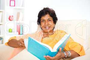 Mature Indian woman reading book