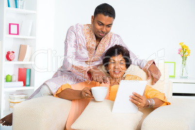 Indian family using computer tablet