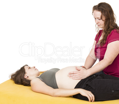 midwife sitting behind pregnant woman