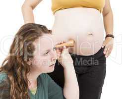 midwife listening at human belly