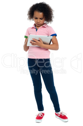 Profile shot of a cute smiling girl with tablet pc.