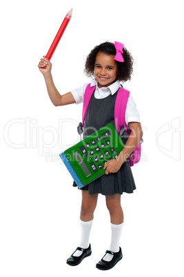 Smart young school girl showing large green calculator