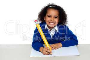 Smart young school girl with long pencil