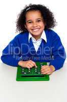 Smiling young school girl with calculator