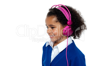 Smiling young school girl with headphones