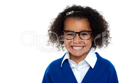 Smiling young school girl with glasses.