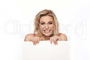 Happy blonde woman with blank sign