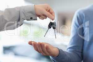 Man giving keys to someone