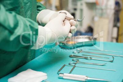 Surgeon choosing a surgical instrument