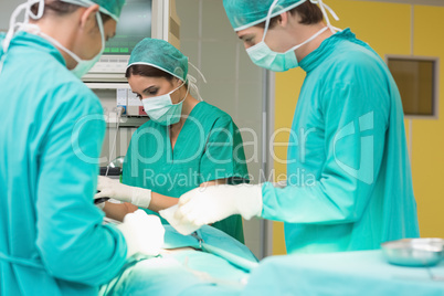 Surgeons working on a patient with his teams