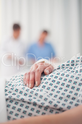 Close-up on the hand of a lying patient in a hospital