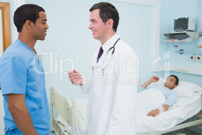 Doctor and a male nurse in a hospital talking