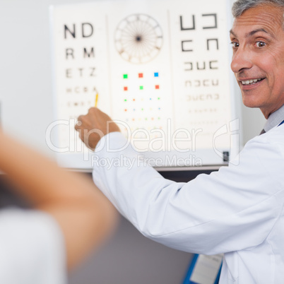 Doctor smiling while doing an eye test on a patient in a hospita