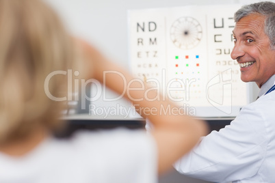 Joyful doctor doing an eye test on a patient in a hospital