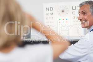 Joyful doctor doing an eye test on a patient in a hospital