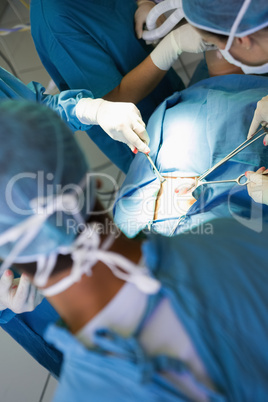 Surgeon performing an operation on a stomach