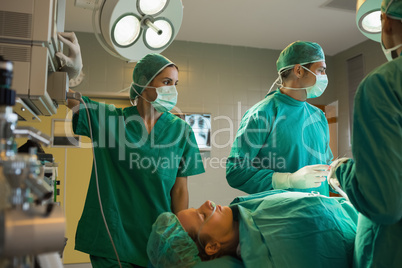 Surgeons working on a female patient
